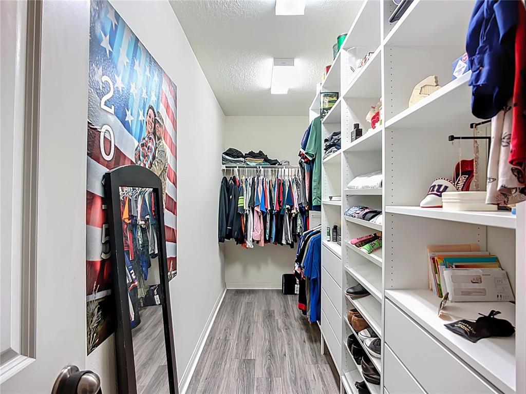 7707 Sunshine Bridge Avenue Gibsonton, FL 33534 - Photo 21 of 33 a view of walk in closet with clothes shoes and a mirror