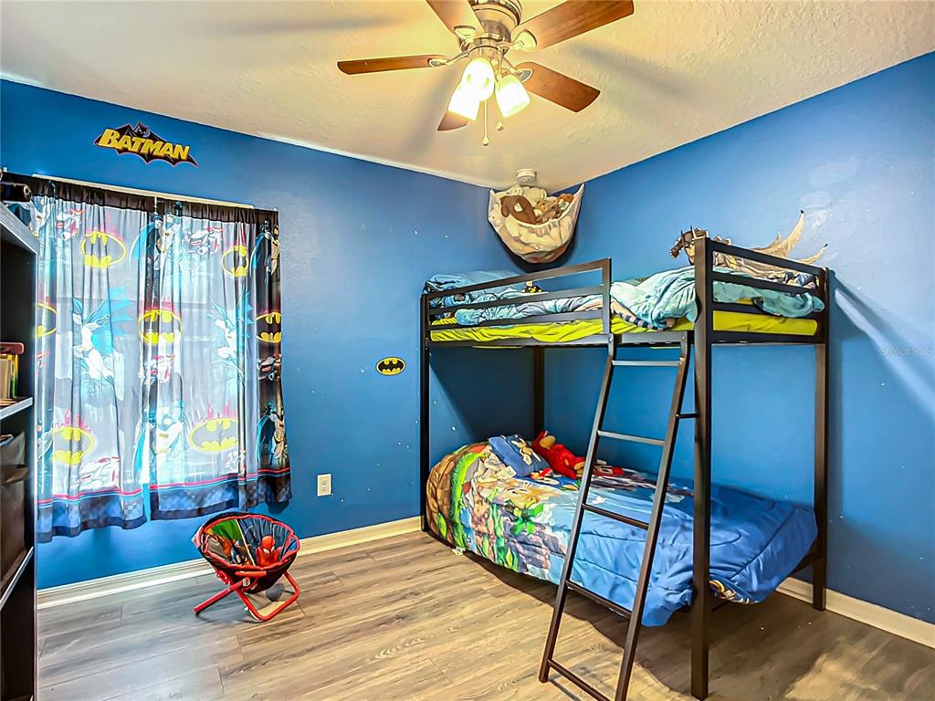 7707 Sunshine Bridge Avenue Gibsonton, FL 33534 - Photo 22 of 33 a bedroom with a bed and a chandelier