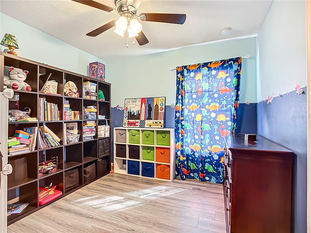 7707 Sunshine Bridge Avenue Gibsonton, FL 33534 - Photo 24 of 33 a view of a livingroom with shelves