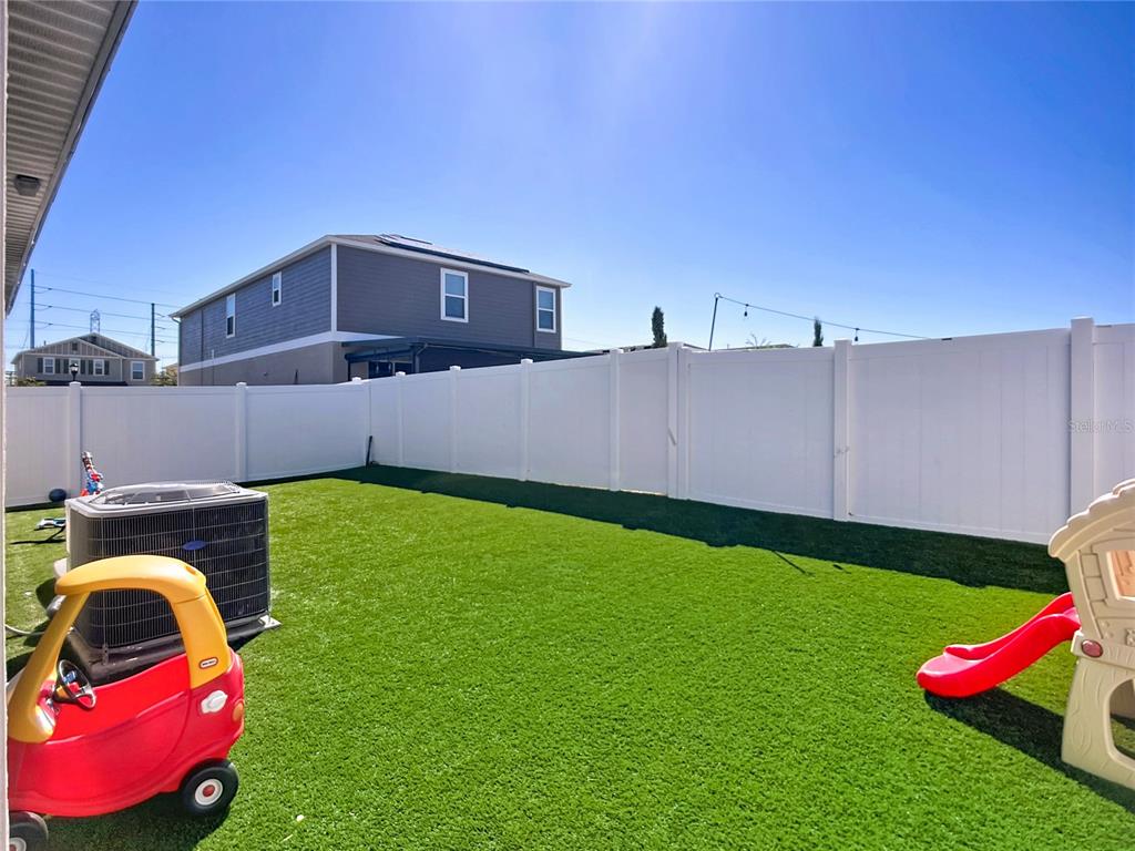 7707 Sunshine Bridge Avenue Gibsonton, FL 33534 - Photo 29 of 33 a front view of a house with a garden and deck