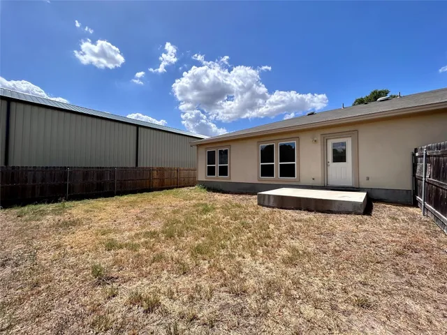 a view of a house with a backyard