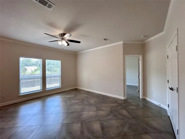 a large kitchen with a cabinets and a ceiling fan