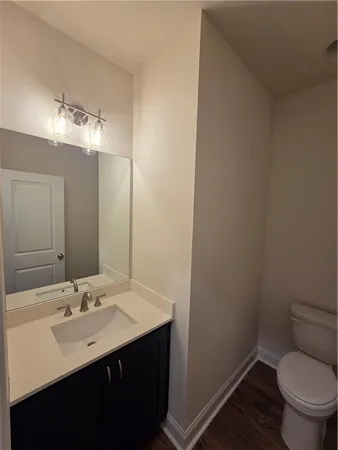 an empty room with wooden floor chandelier fan and windows