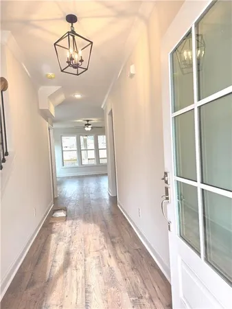 a view of kitchen with kitchen island stainless steel appliances wooden floor and window