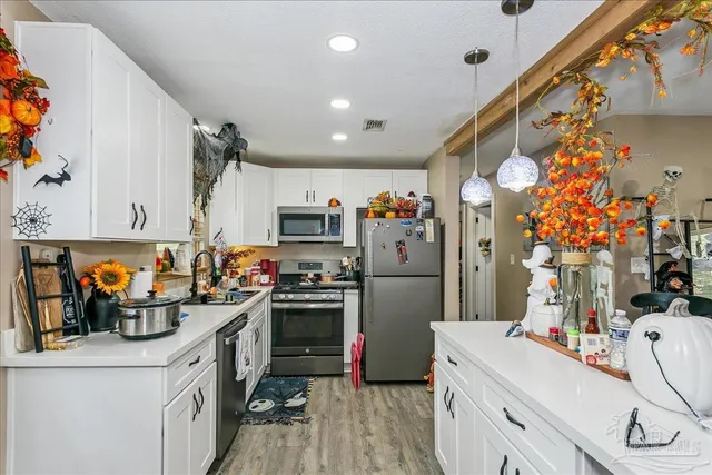 a kitchen with refrigerator and cabinets