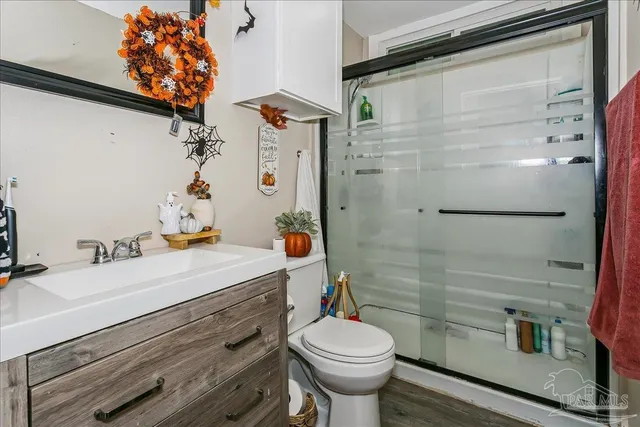 a bathroom with a sink toilet and shower