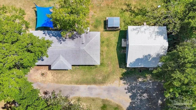 an aerial view of a house with outdoor space pool seating area and yard