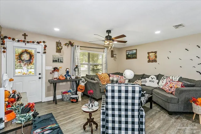 a living room with furniture a rug and a window