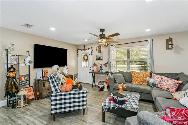 a living room with furniture and a flat screen tv