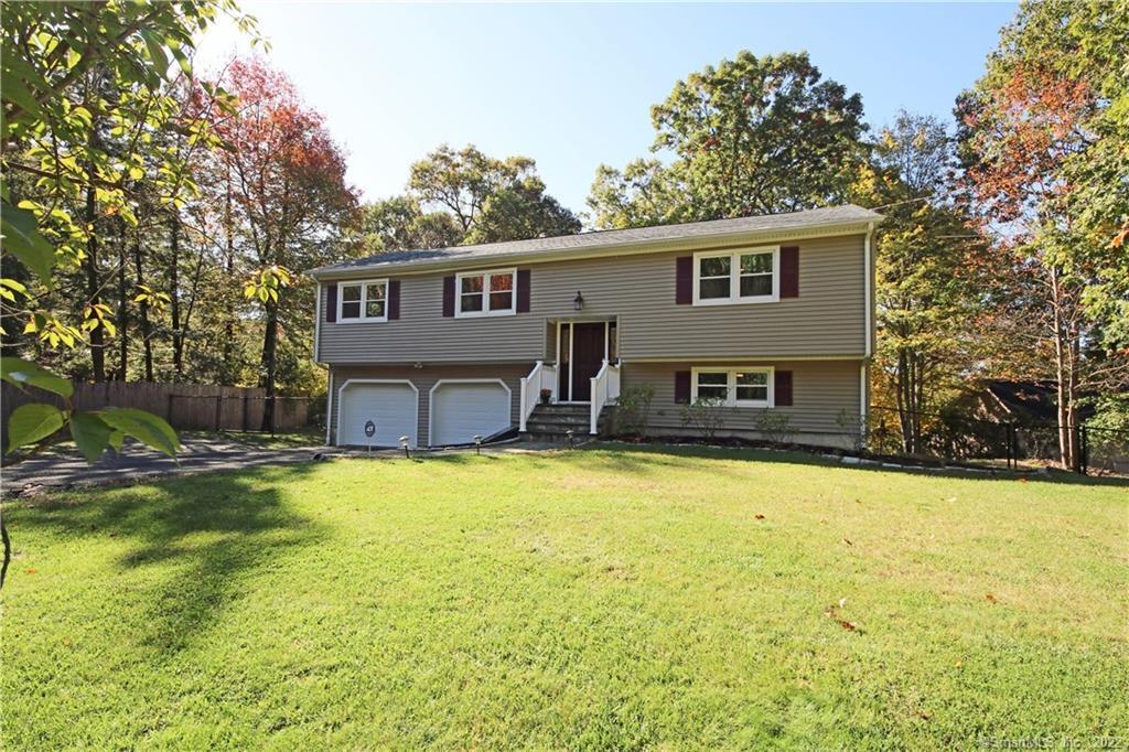 536 Bennetts Farm Road Ridgefield, CT 06877 - Photo 1 of 1 a front view of house with yard and trees in the background