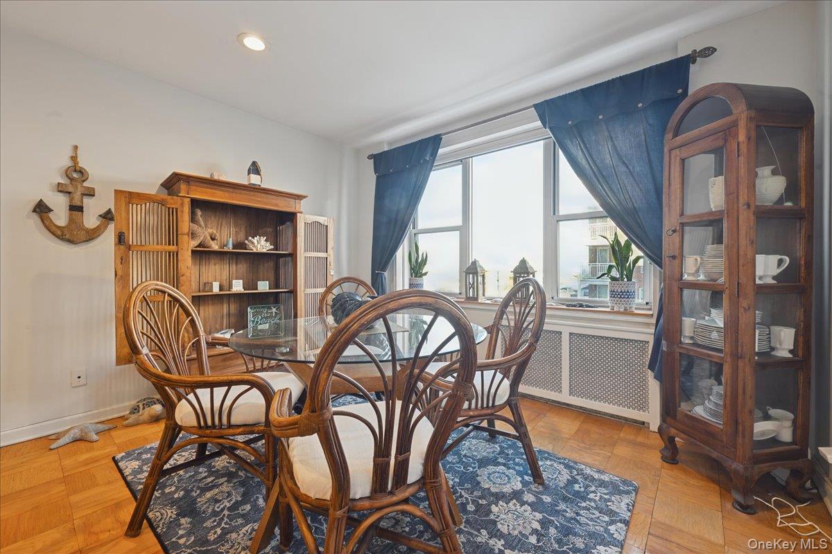 700 Shore Road, Unit 4O Long Beach, NY 11561 - Photo 16 of 42 a view of a dining room with furniture window and wooden floor