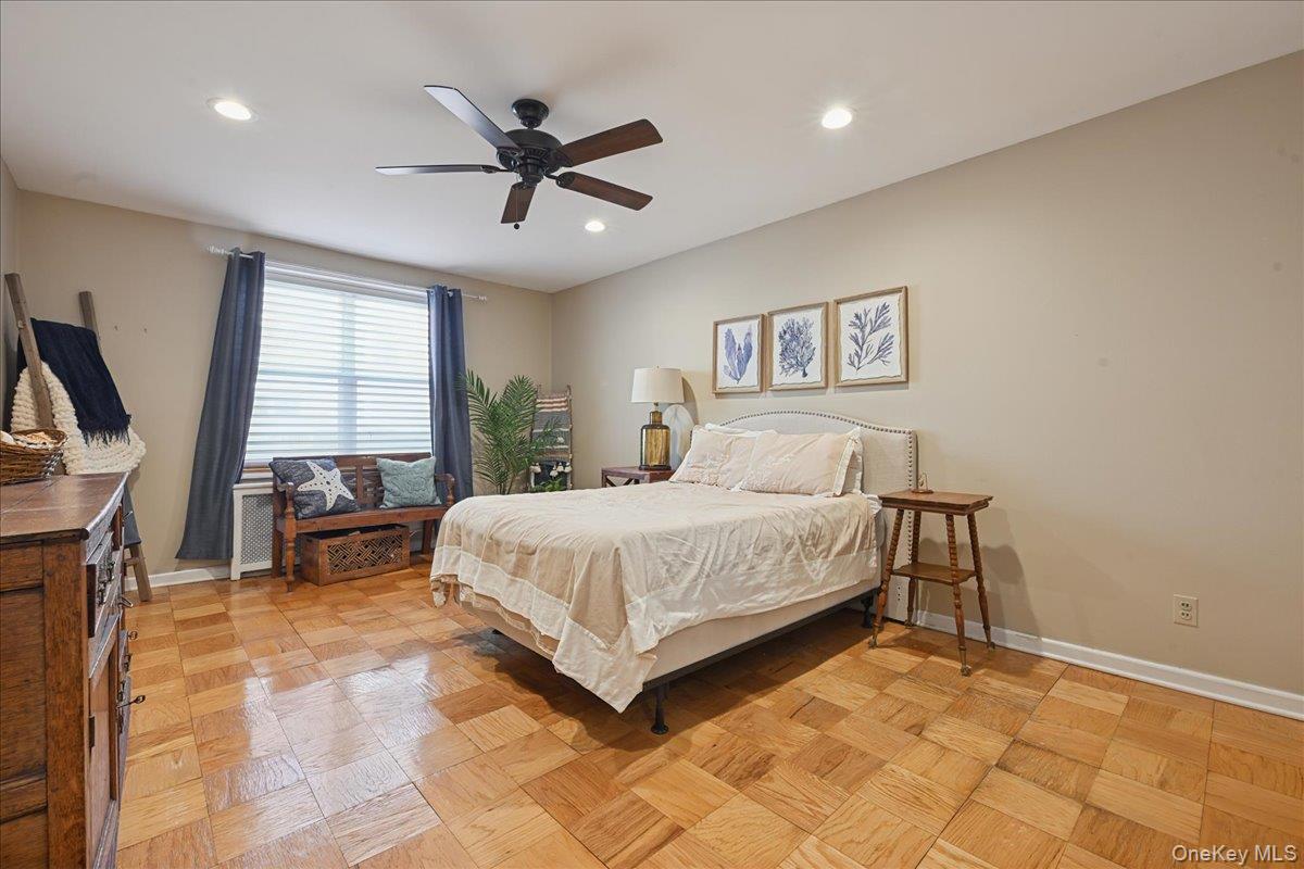 700 Shore Road, Unit 4O Long Beach, NY 11561 - Photo 20 of 42 a bedroom with a bed a fireplace and a large window