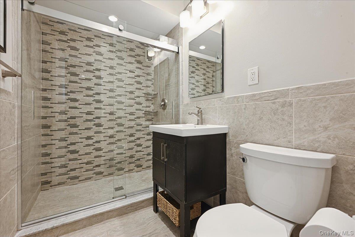 700 Shore Road, Unit 4O Long Beach, NY 11561 - Photo 24 of 42 a bathroom with a toilet sink and shower