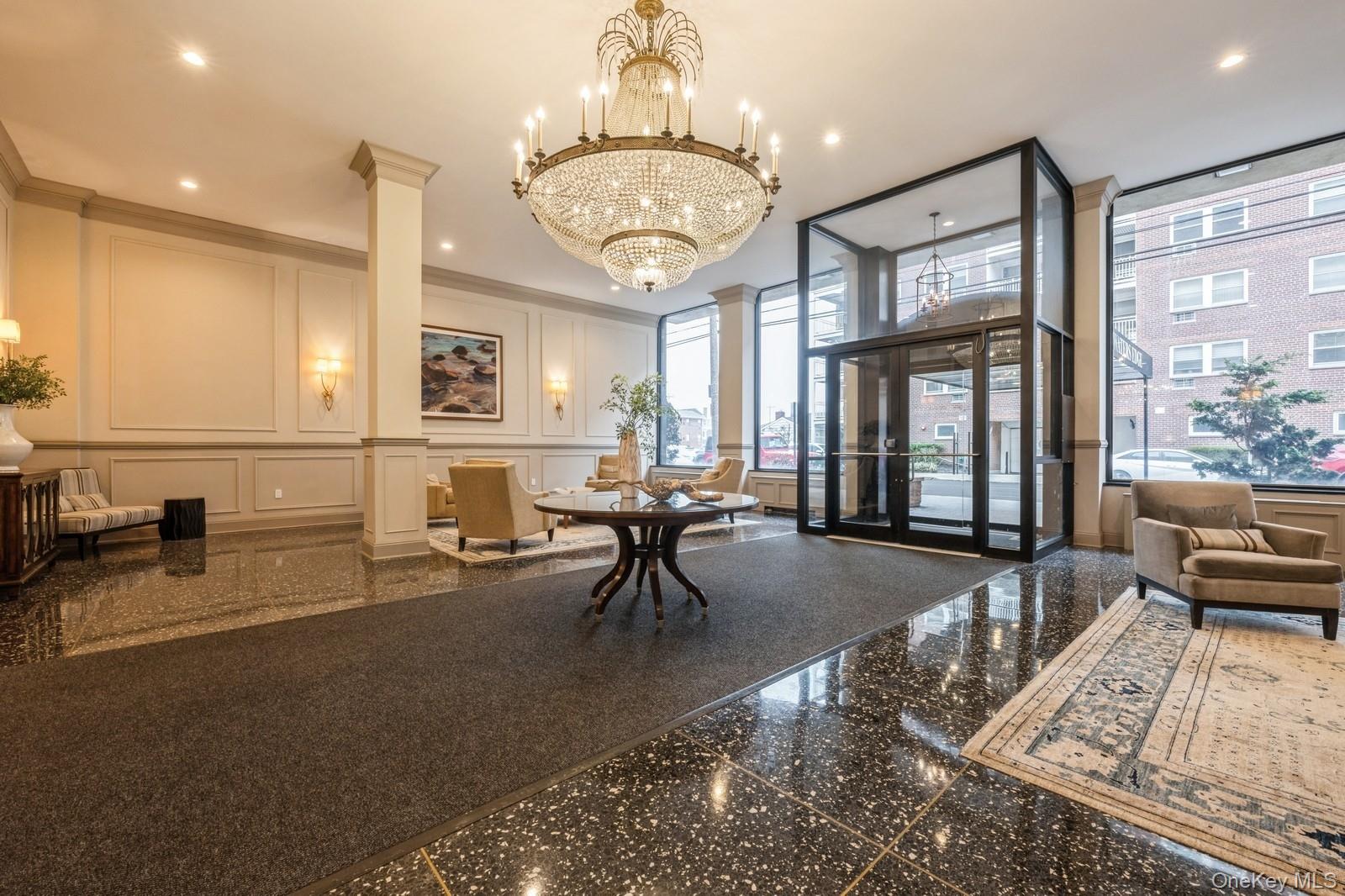 700 Shore Road, Unit 4O Long Beach, NY 11561 - Photo 3 of 42 a living room with furniture a chandelier and large window