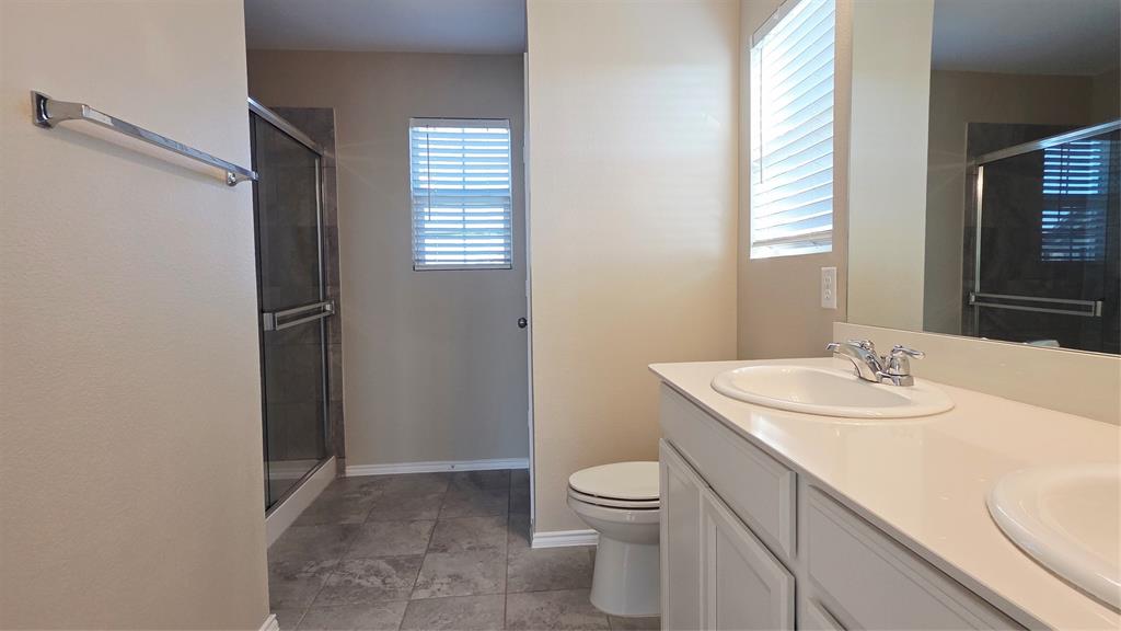 1804 Arcola Court Forney, TX 75126 - Photo 24 of 27 a bathroom with a sink a toilet and shower