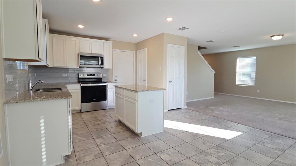 1804 Arcola Court Forney, TX 75126 - Photo 6 of 27 a kitchen with stainless steel appliances granite countertop a refrigerator sink and cabinets