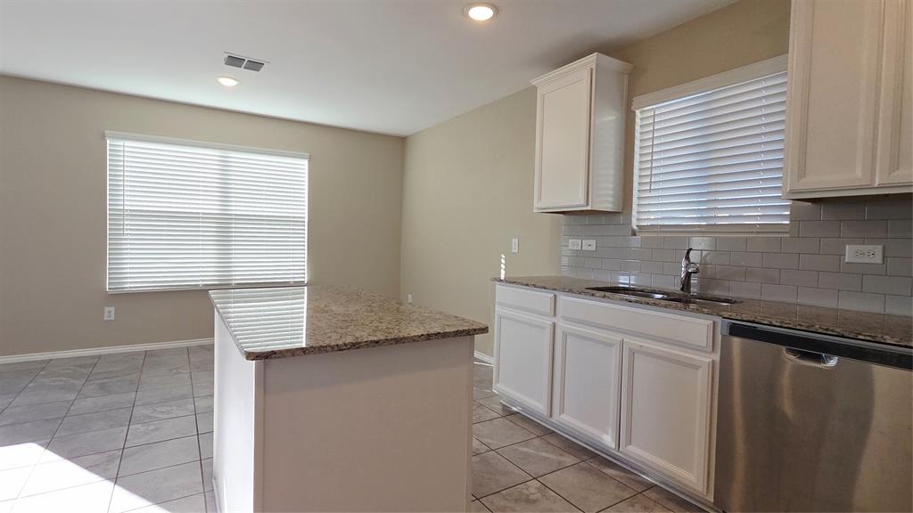 1804 Arcola Court Forney, TX 75126 - Photo 10 of 27 a kitchen with stainless steel appliances granite countertop a sink and a window