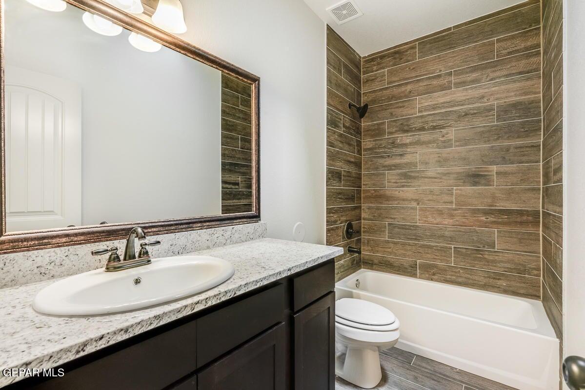 513 Caddo Lane Clint, TX 79836 - Photo 15 of 28 a bathroom with a granite countertop sink toilet and shower