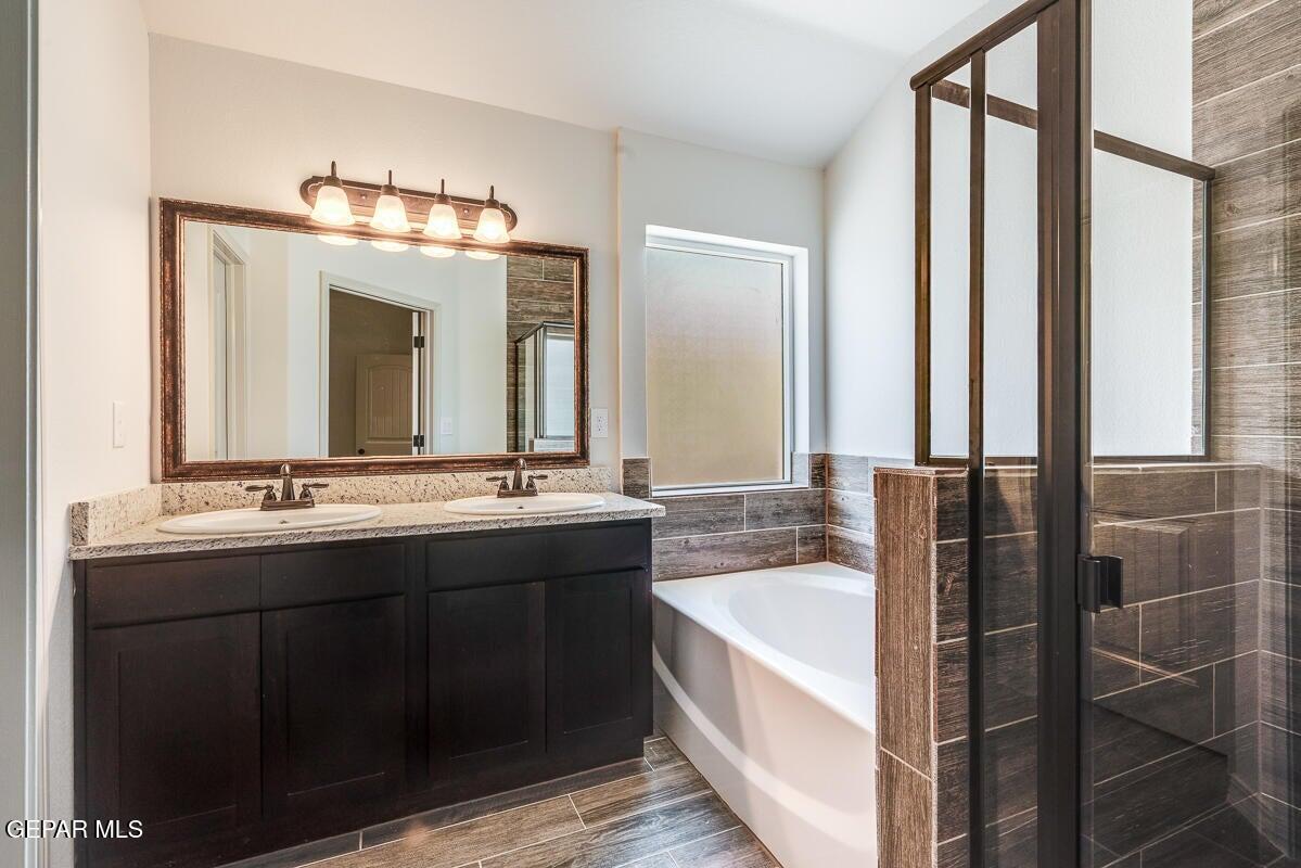 513 Caddo Lane Clint, TX 79836 - Photo 25 of 28 a bathroom with a double vanity sink and a mirror