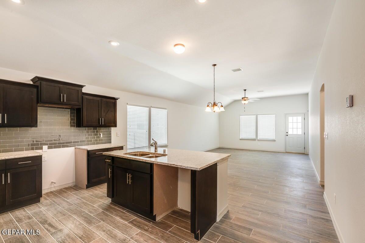 513 Caddo Lane Clint, TX 79836 - Photo 5 of 28 a kitchen with stainless steel appliances granite countertop a sink stove and refrigerator