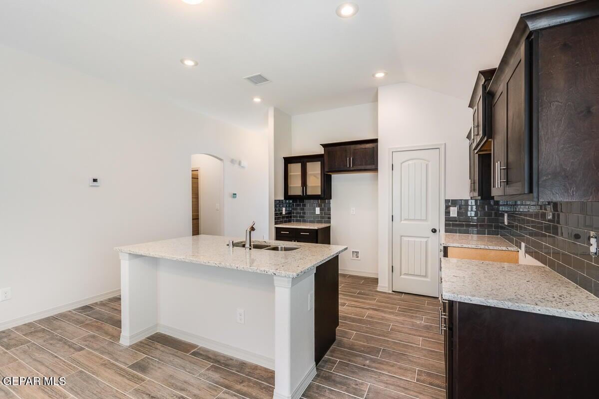 513 Caddo Lane Clint, TX 79836 - Photo 9 of 28 a kitchen with stainless steel appliances granite countertop a sink stove and refrigerator
