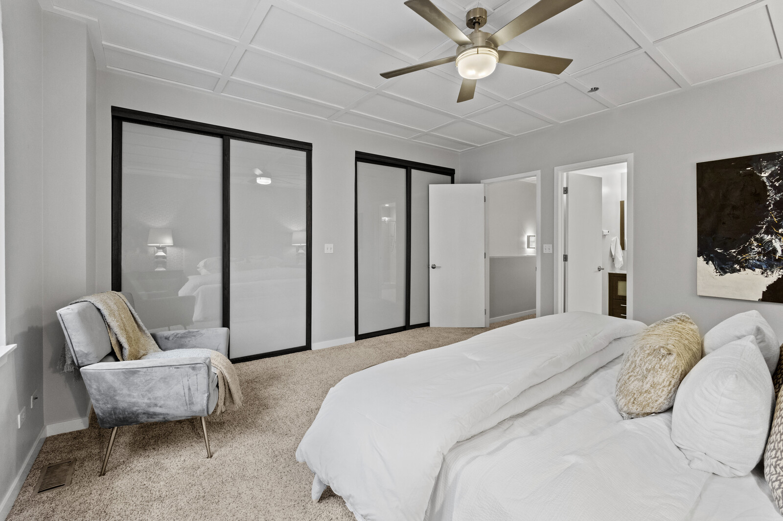 16 North May Street, Unit 511 Chicago, IL 60607 - Photo 13 of 26 a spacious bedroom with a bed and ceiling fan