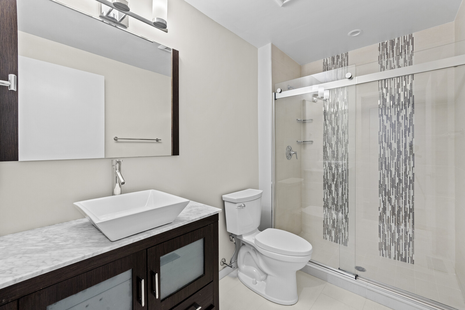 16 North May Street, Unit 511 Chicago, IL 60607 - Photo 21 of 26 a bathroom with a sink a toilet a mirror and shower