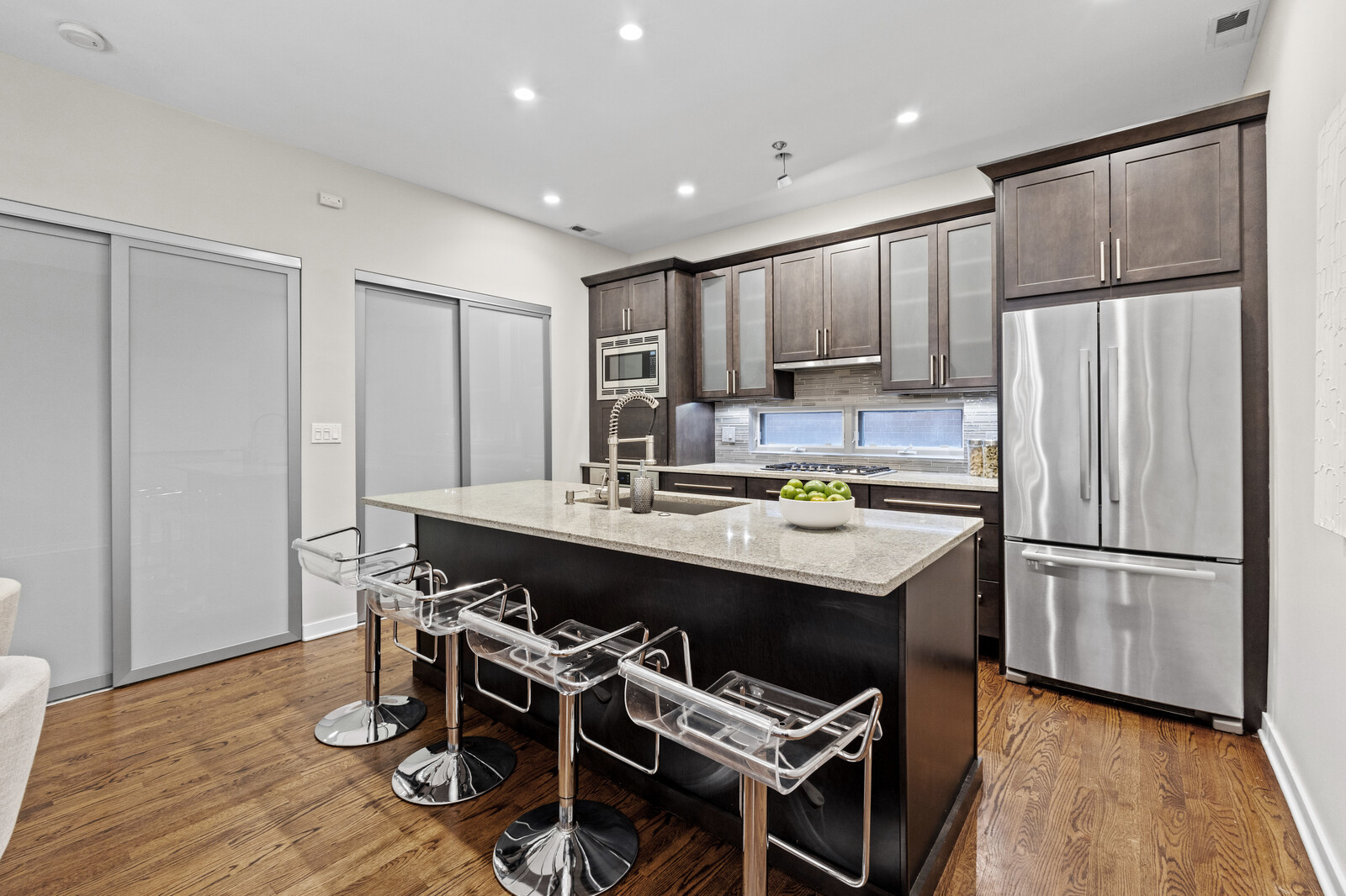 16 North May Street, Unit 511 Chicago, IL 60607 - Photo 5 of 26 a kitchen with kitchen island a sink appliances and cabinets