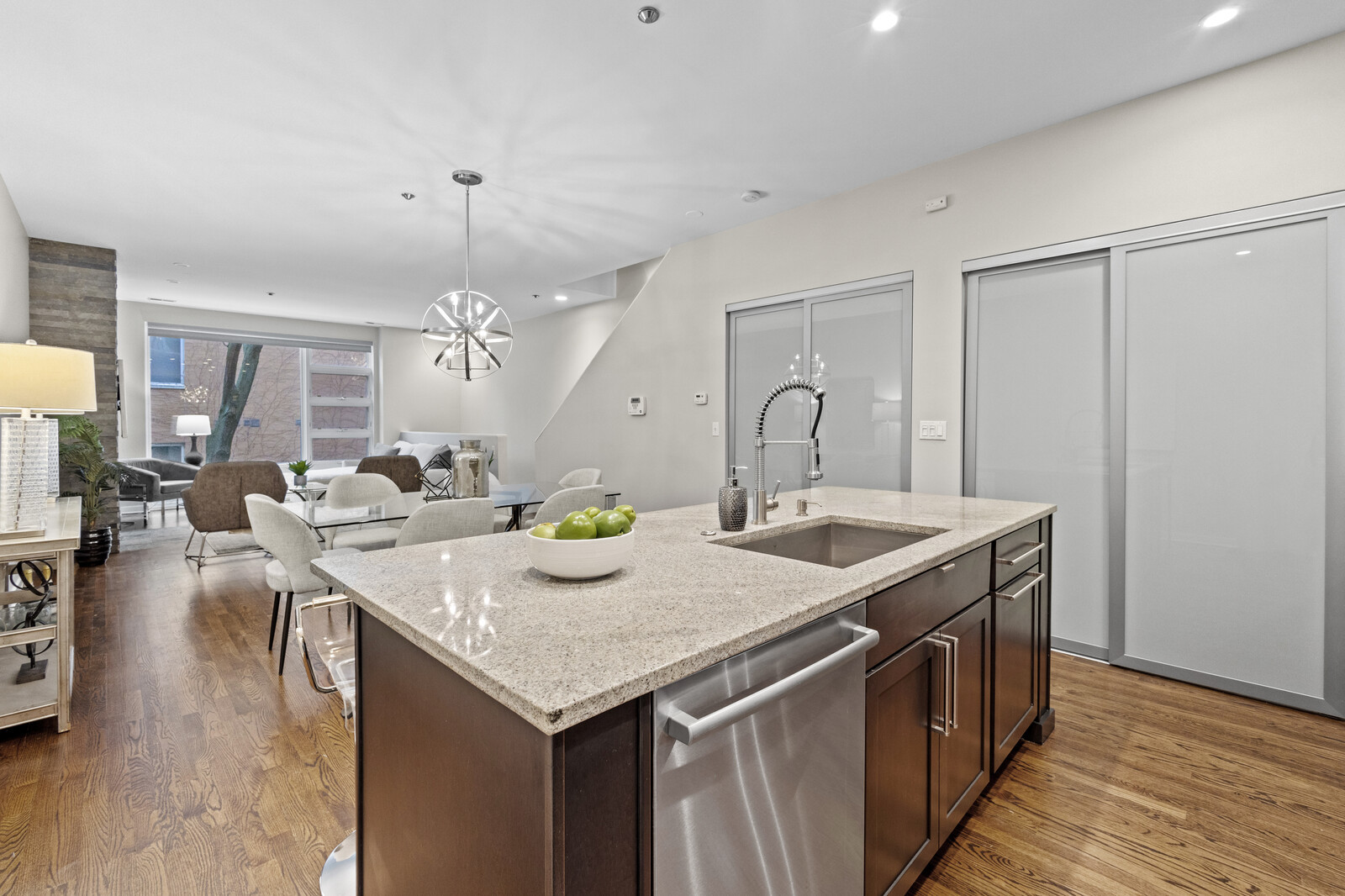 16 North May Street, Unit 511 Chicago, IL 60607 - Photo 7 of 26 a hall with kitchen island a sink and a stove