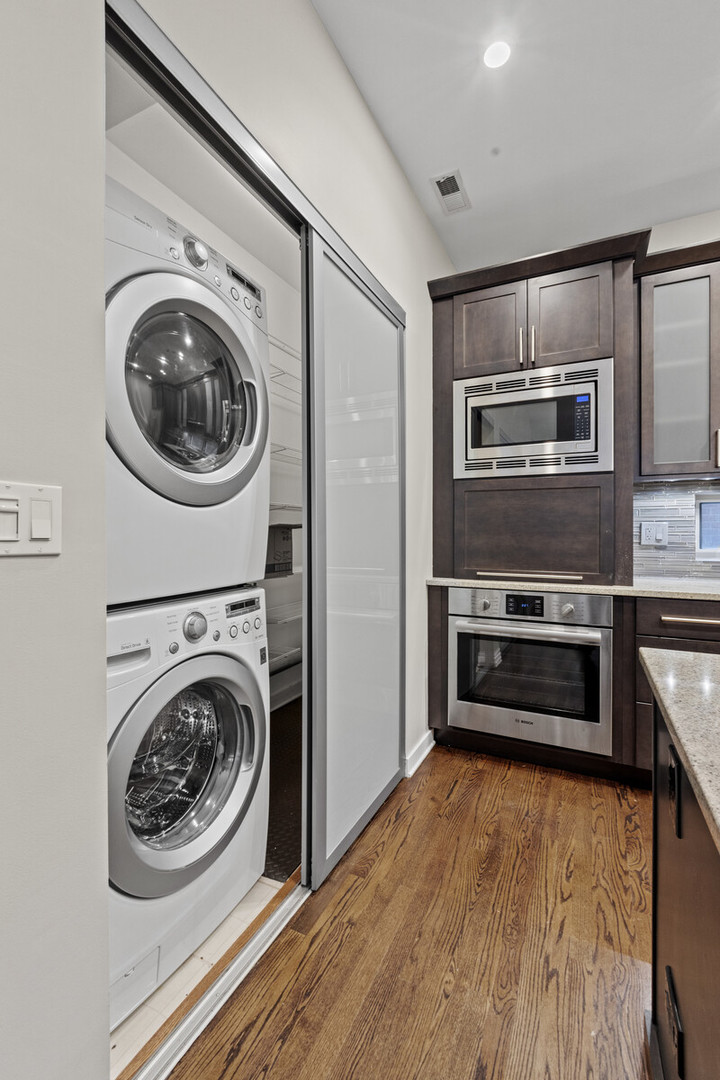 16 North May Street, Unit 511 Chicago, IL 60607 - Photo 8 of 26 a view of a hallway with washer and dryer