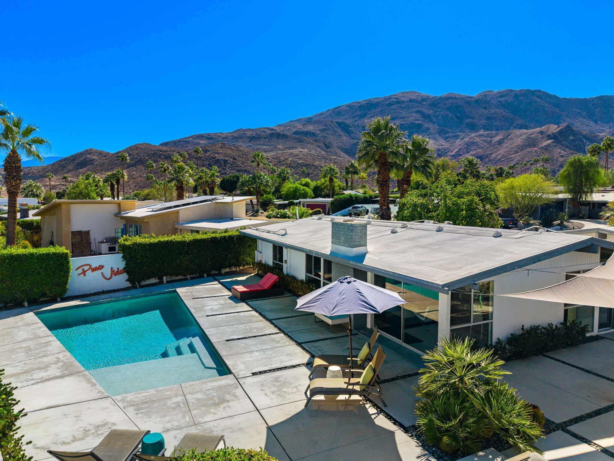 an aerial view of a house with swimming pool garden view and seating space