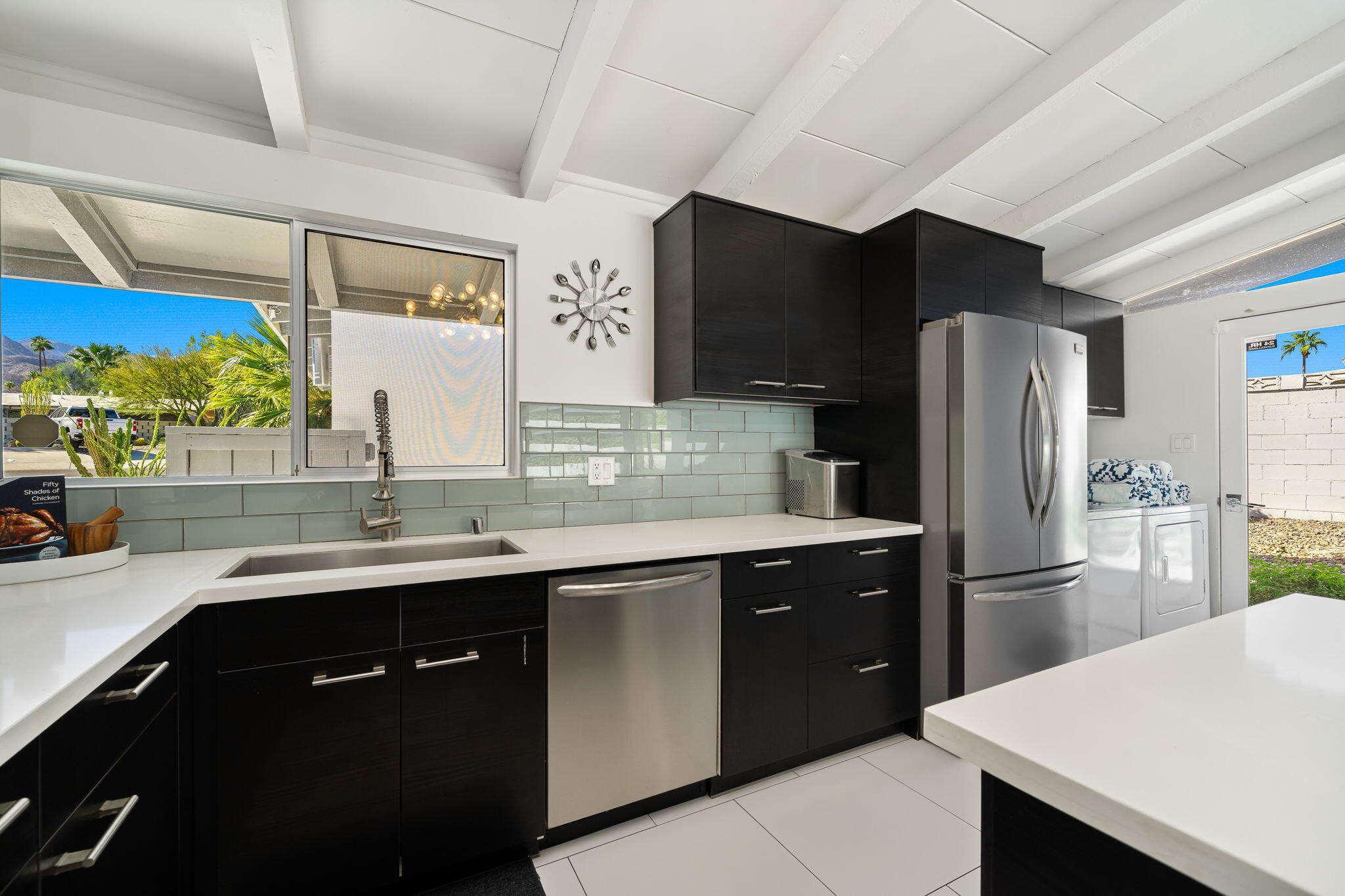 71718 Tunis Road Rancho Mirage, CA 92270 - Photo 20 of 43 a kitchen with stainless steel appliances a sink cabinets and a refrigerator