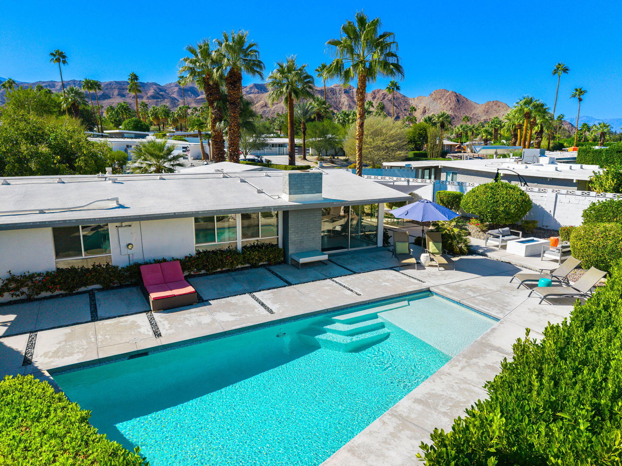 71718 Tunis Road Rancho Mirage, CA 92270 - Photo 3 of 43 a aerial view of a house with swimming pool and a yard