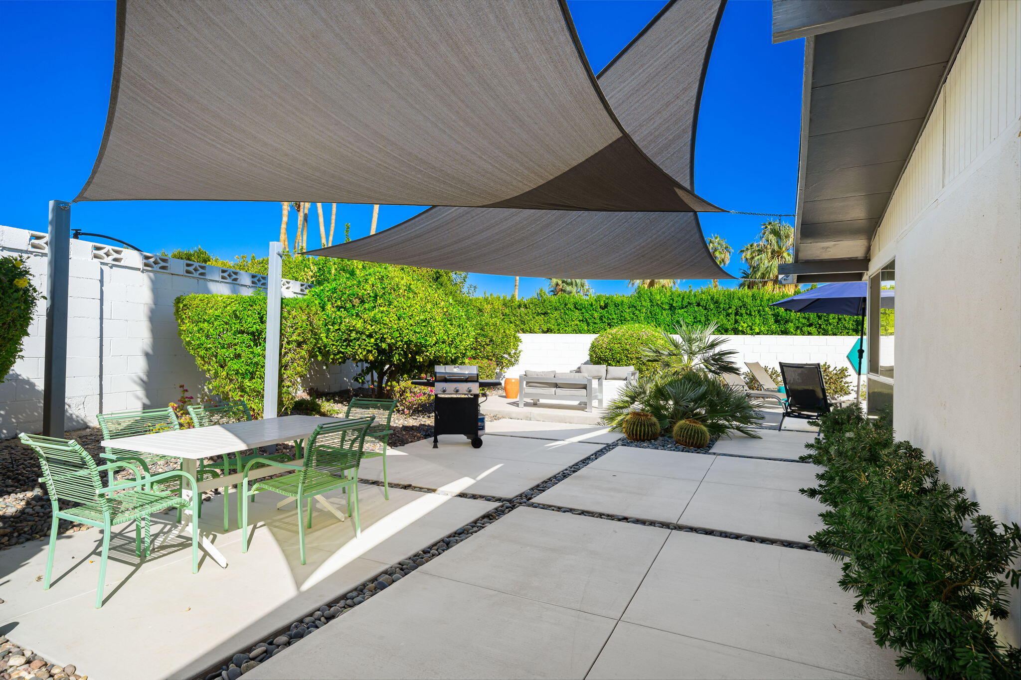 71718 Tunis Road Rancho Mirage, CA 92270 - Photo 33 of 43 a view of a patio with table and chairs under an umbrella