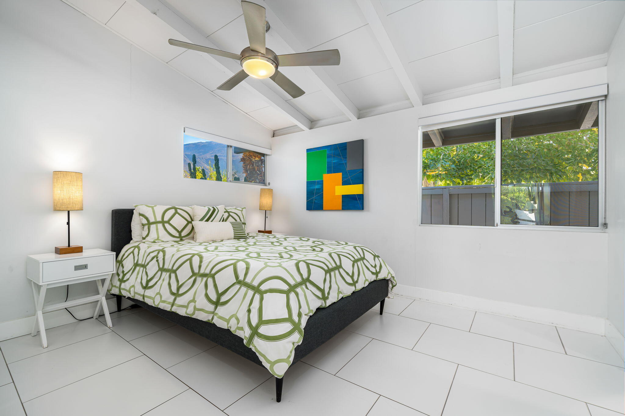 71718 Tunis Road Rancho Mirage, CA 92270 - Photo 34 of 43 a bedroom with a bed and a chandelier