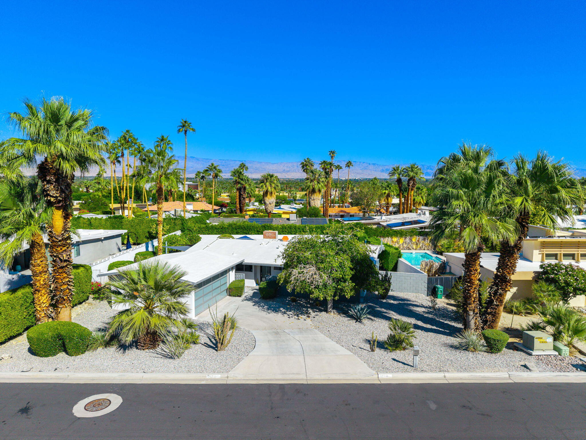 71718 Tunis Road Rancho Mirage, CA 92270 - Photo 4 of 43 a view of a street with a tree