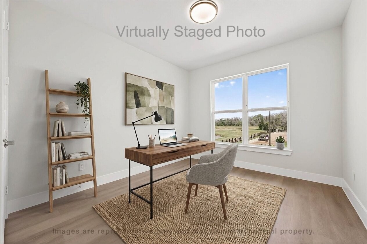 10719 Mason Road, Unit 15 Richmond, TX 77406 - Photo 15 of 50 Virtual Staging - Airy home office featuring a modern wooden desk, a gray chair, and a leaning bookshelf