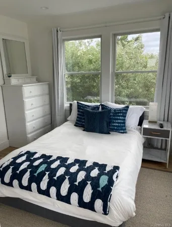 a bedroom with a bed and a television