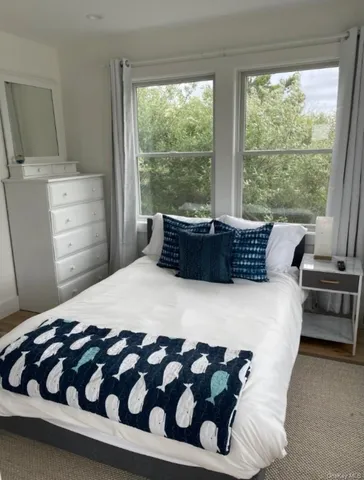 a bedroom with a bed and a television