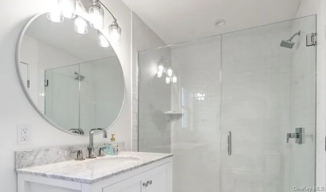 a bathroom with a sink vanity and a mirror