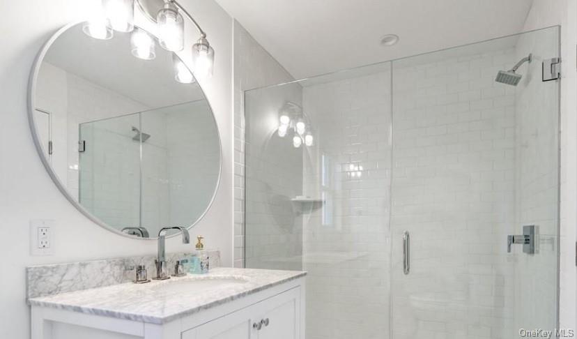 800 Dune Road Westhampton Beach, NY 11978 - Photo 15 of 19 a bathroom with a sink vanity and a mirror