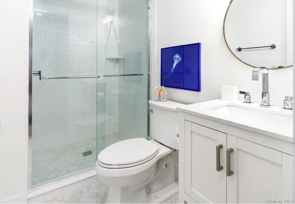 a bathroom with a sink a toilet and shower