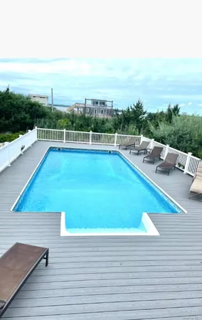 a view of a swimming pool with lounge chairs