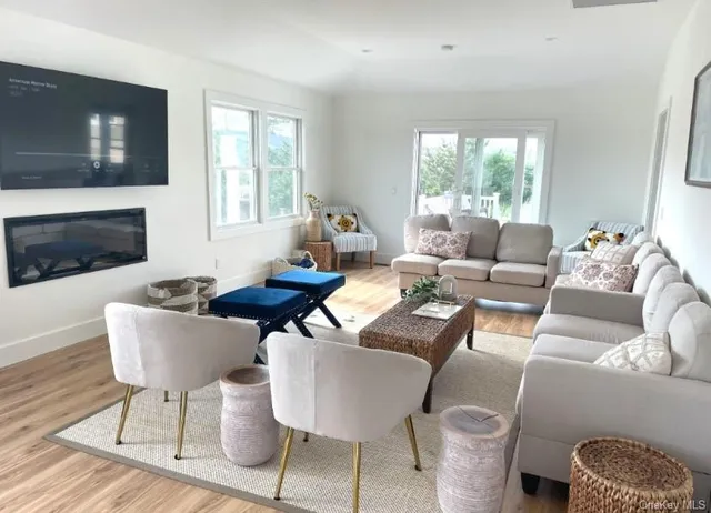 a kitchen with kitchen island a dining table chairs and a wooden floor