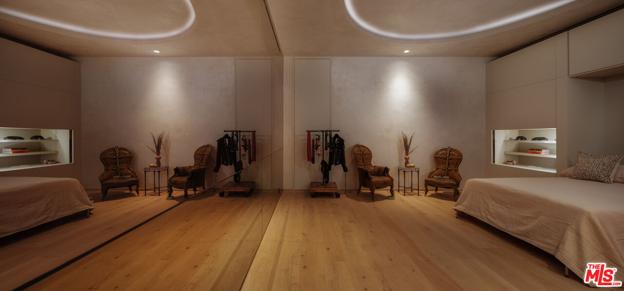 9126 Cordell Drive Los Angeles, CA 90069 - Photo 15 of 27 a room with gym equipment and a mirror