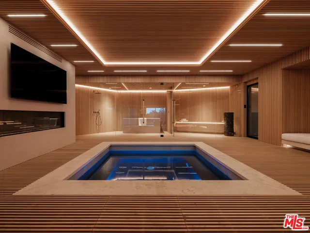 a bedroom with a bed and a night stand