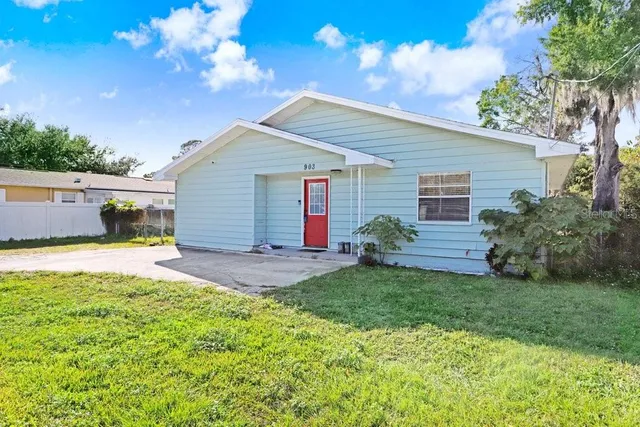 a view of a house with backyard and sitting area