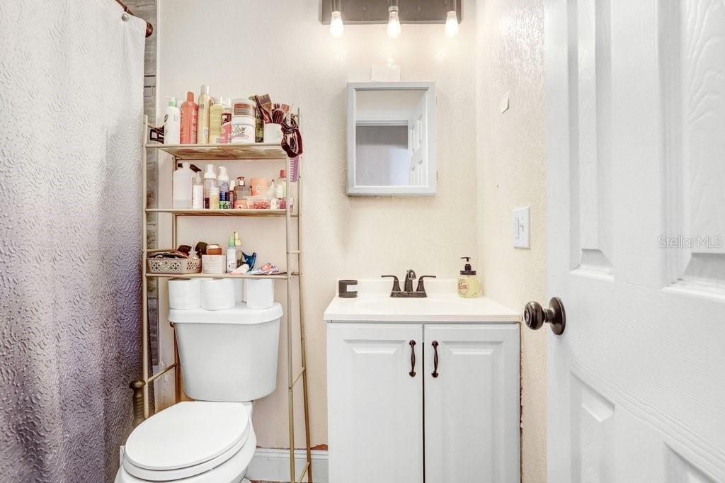903 North Park Road Plant City, FL 33563 - Photo 18 of 28 a white toilet sitting next to a bathroom sink