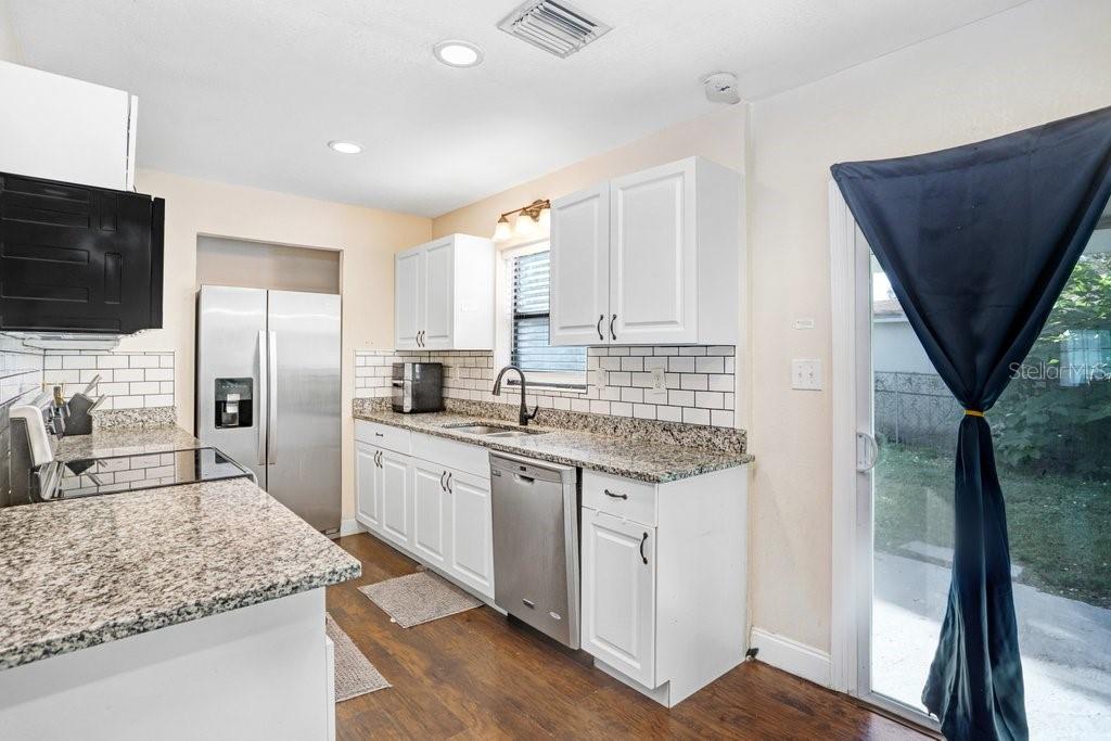 903 North Park Road Plant City, FL 33563 - Photo 5 of 28 a kitchen with stainless steel appliances granite countertop a sink stove and refrigerator