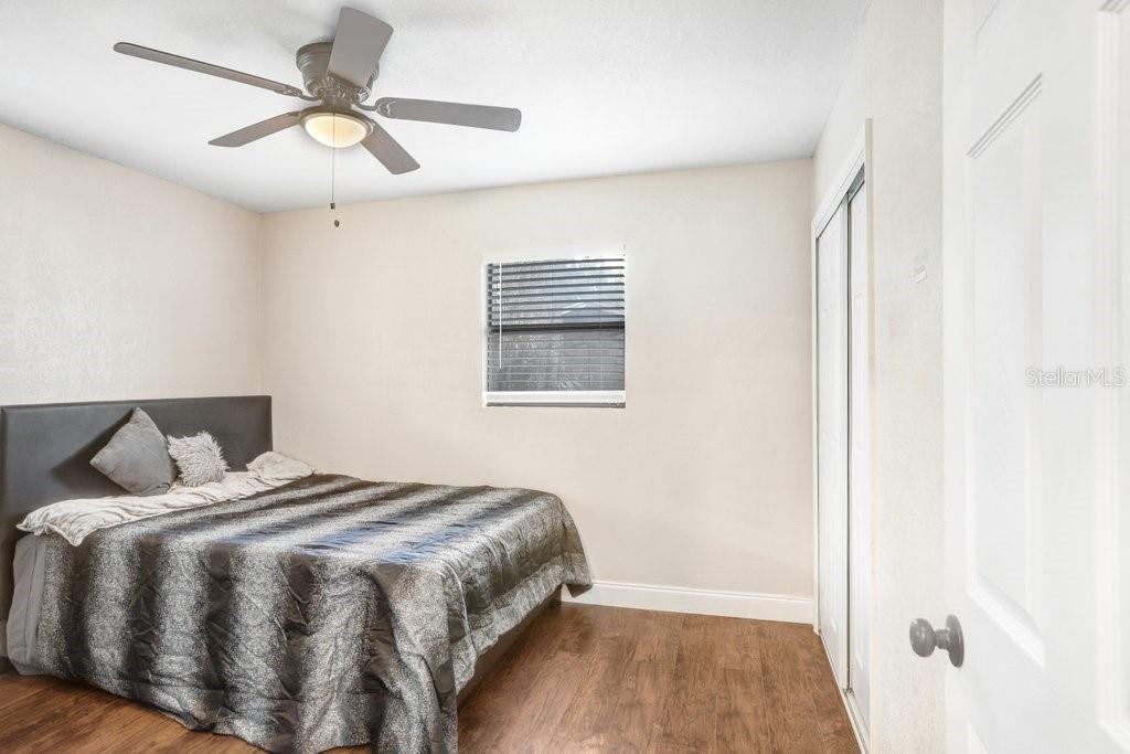 903 North Park Road Plant City, FL 33563 - Photo 9 of 28 a bedroom with a bed and wooden floor